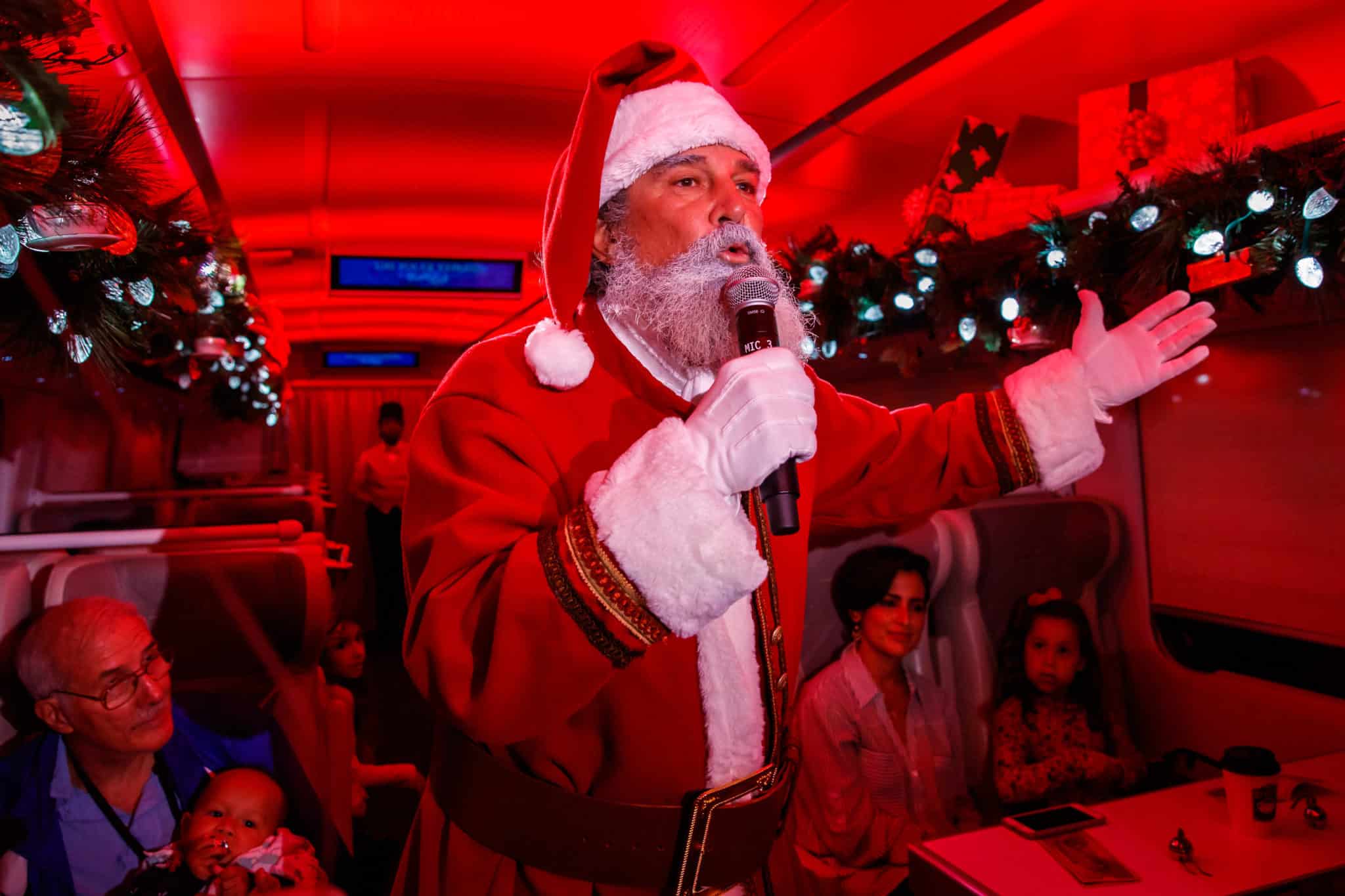 Santa Claus speaking to guests aboard the train