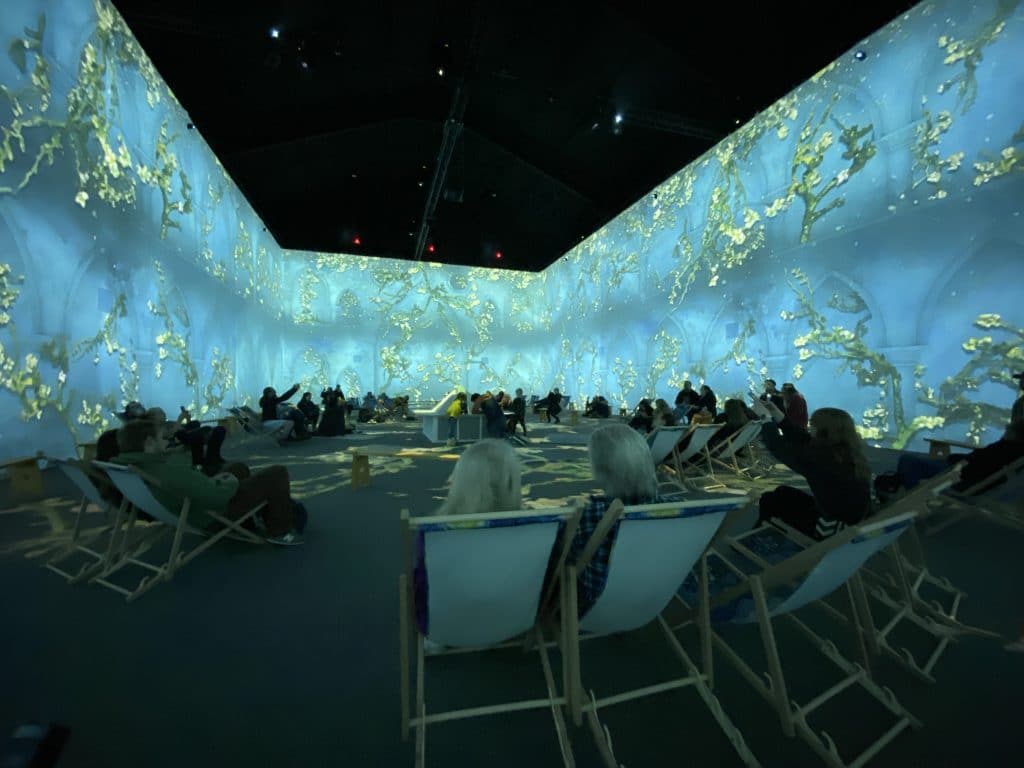 Guests at Van Gogh: The Immersive Experience viewing "Almond Blossom"