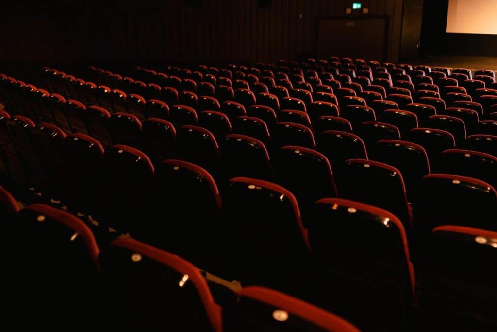 An array of red chairs in a movie theater