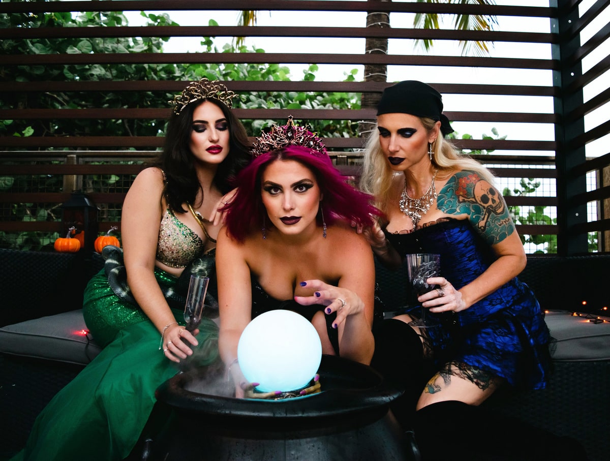 Trio of mermaids in front of a crystal ball for HallowFINS Festival
