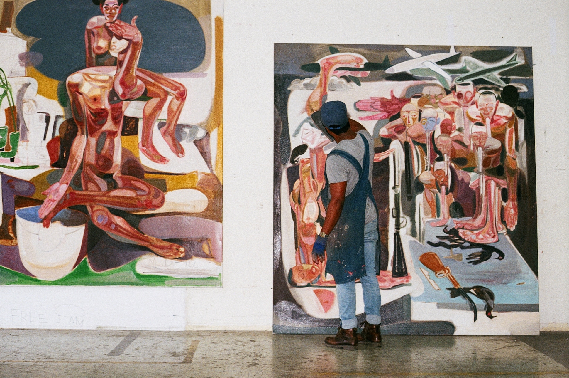 Ethiopian Contemporary artist Tesfaye Urgessa working on two paintings