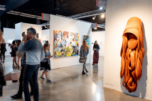 People walk around an art gallery