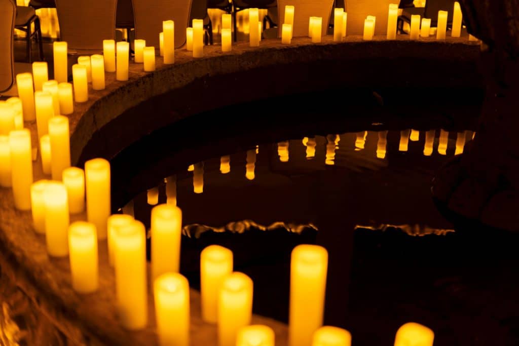 Candles surrounding a fountain inside Coral Gables Congregational Church for a Candlelight concert.