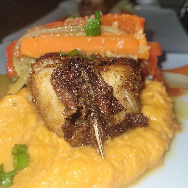 Fried red snapper steak over mashed sweet potato