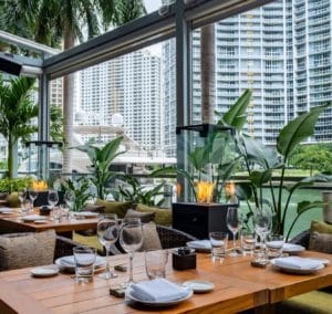 Stunning covered patio at Zuma Miami, with heaters and plentiful greenery