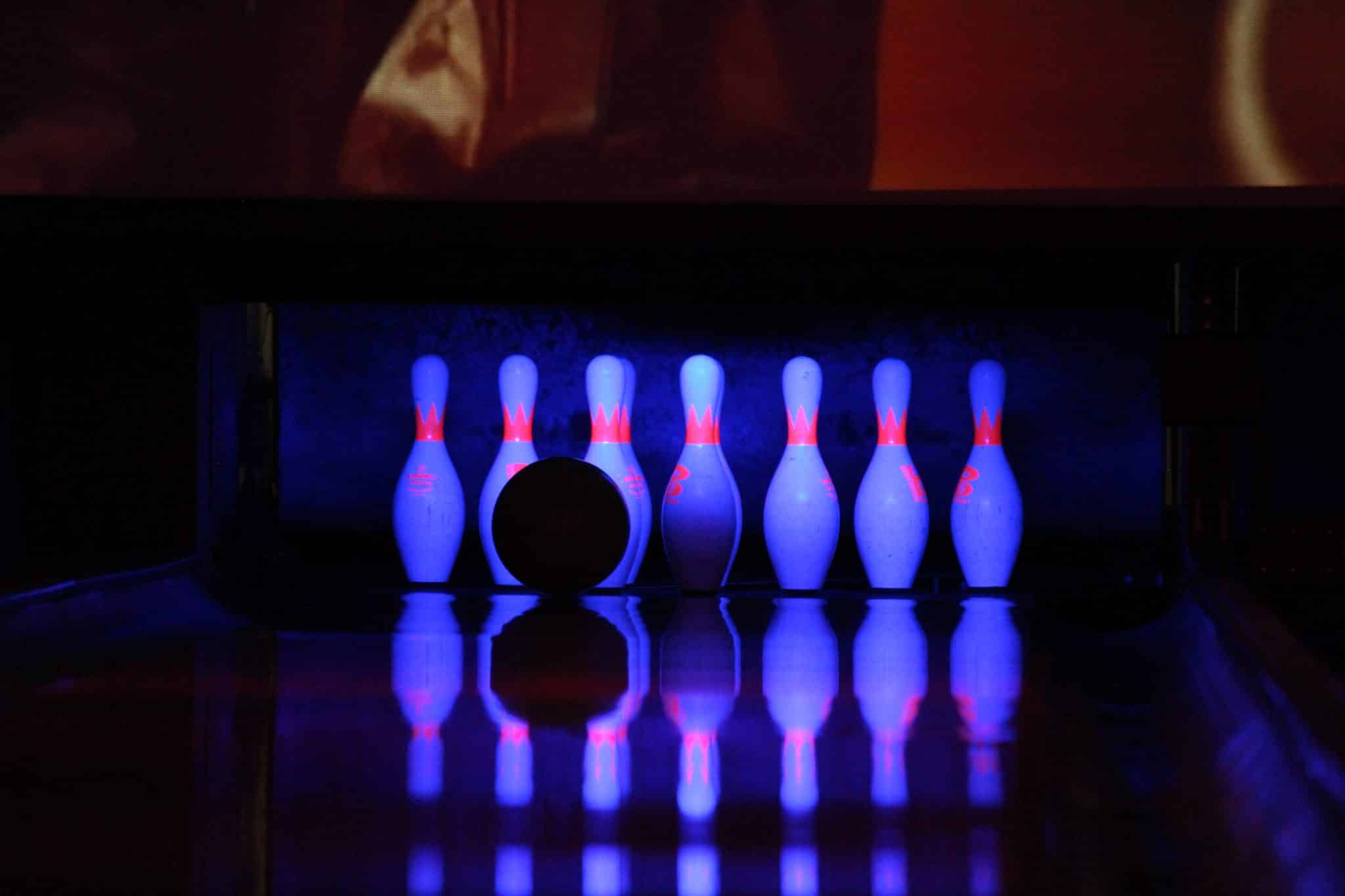 A bowling alley with bowling pins and a bowling ball
