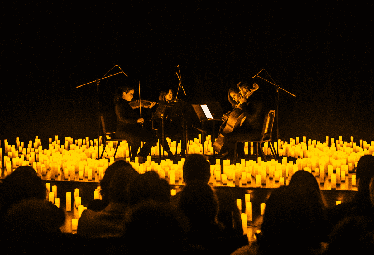 A string quartet performs while surrounded by candles at a Candlelight concert 